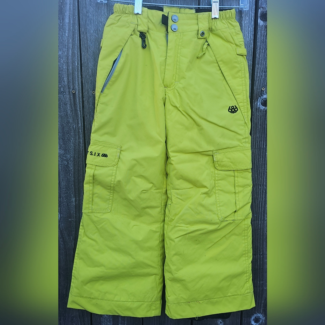 Yellow 686 Brand Youth Cargo Snowboard Pants Feature Multiple Pockets